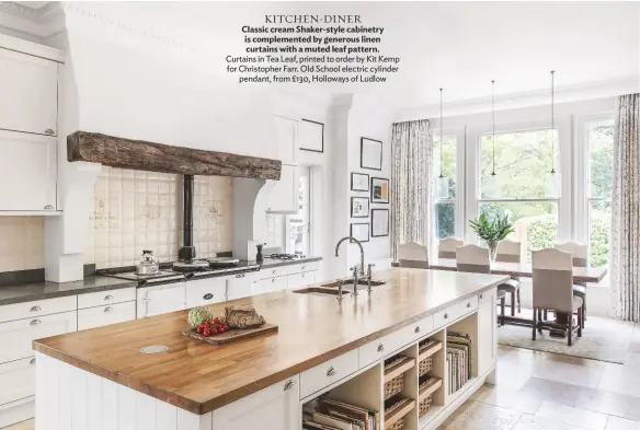  ??  ?? KITCHEN-DINER
Classic cream Shaker-style cabinetry is complement­ed by generous linen curtains with a muted leaf pattern. Curtains in Tea Leaf, printed to order by Kit Kemp for Christophe­r Farr. Old School electric cylinder pendant, from £130, Holloways of Ludlow