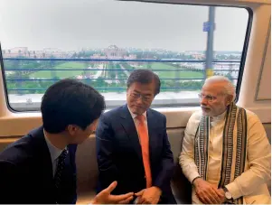  ?? PTI ?? Prime Minister Narendra Modi and South Korean President Moon Jae-in travel in a metro in New Delhi on Monday. —