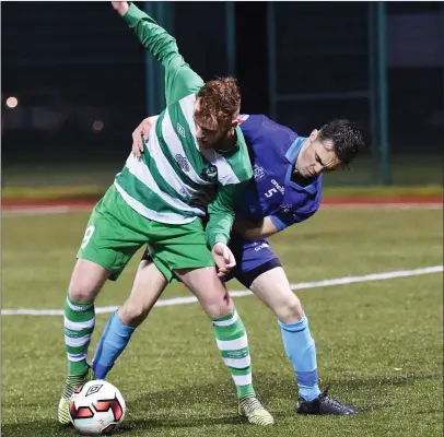  ??  ?? Stephen McCarthy, Killarney Celtic, comes under pressure from Rian O’Sullivan, Dingle Bay Rovers, at Celtic Park, Killarney on Friday. Photo by Michelle Cooper Galvin