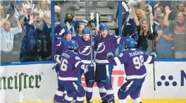  ?? JULIO AGUILAR/GETTY ?? Steven Stamkos (91) of the Tampa Bay Lightning celebrates with teammates Jan Rutta (44), Ondrej Palat (18), Mikhail Sergachev (98) and Nikita Kucherov (86) after scoring a goal against the New York Rangers during the second period in Game Six of the Eastern Conference final on Saturday.