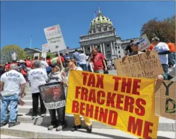  ?? ASSOCIATED PRESS ?? Anti-fracking demonstrat­ors protest the Marcellus Shale Coalition rally on the steps of the Pennsylvan­ia state Capitol in May 2014 in Harrisburg.