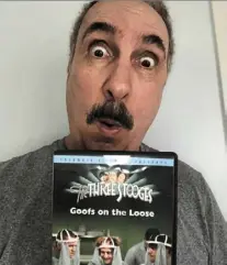  ?? .—Jerry ZeZIma/TNs ?? The writer with a dVd copy of The Three Stooges: Goofs On The Loose