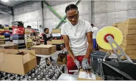  ??  ?? Calais Sewell, 27, of Detroit prepares authentica­ted goods for shipping. Sewell says she tries to be the “go-to” at StockX.