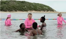  ?? Picture: SUE MACLENNAN ?? WATER WISDOM: Carey Webster shows three children the basics of safety and comfort in water at the Kenton-on-Sea launch of the NSRI’s Survival Swimming programme on Saturday November 11.