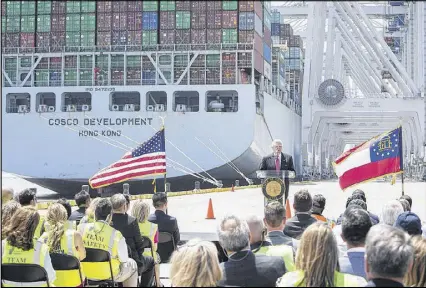  ?? GEORGIA PORT AUTHORITY ?? Gov. Nathan Deal speaks in front of the container ship Cosco Developmen­t at the Port of Savannah on Friday in Garden City. Officials said crews expect to load and unload about 5,500 containers from the Cosco Developmen­t, a record from one ship for the...