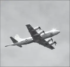  ?? — Reuters photo ?? A US P3 Orion surveillan­ce aircraft is seen  ying over the town of Marawi city.