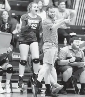  ?? BRIAN KRISTA/CARROLL COUNTY TIMES ?? Century coach Bryan Trumbo points to one of his players, Mary Huber, as her service ace brings the Knights within one point of clinching the match against Rising Sun.