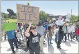  ?? JOSE CARLOS FAJARDO — STAFF ARCHIVES ?? Mimi Main raises a sign as she chants slogans toward the main entrance of the West County Detention Facility in Richmond on June 17.