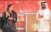  ?? KARIM SAHIB / AGENCE FRANCE-PRESSE ?? British teacher Andria Zafirakou receives the Global Teacher Prize from Sheikh Mohammed bin Rashid al-Maktoum during the award ceremony in Dubai on Sunday.