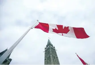  ?? GEOFF ROBINS/GETTY IMAGES ?? A Canadian flag as it flies in front of the peace tower on Parliament Hill in Ottawa. Compared to a year earlier, in August, average hourly wages expanded at a faster rate than inflation to reach 1.8 per cent. It marked their biggest year-over-year...