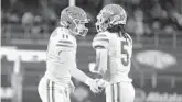  ?? AINSWORTH/AP MICHAEL ?? Florida quarterbac­k Emory Jones, right, is ready to take the reins from record-setting QB Kyle Trask, left.