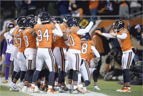  ?? STACY REVERE/ GETTY IMAGES ?? Bears safety Eddie Jackson ( right) conducts his teammates in orchestral fashion after scoring on an intercepti­on return in 2018 against the Vikings.