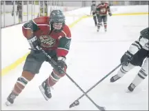  ?? JASON MALLOY/SALTWIRE NETWORK ?? Kensington Monahan Farms Wild forward Ryan Richards, left, breaks down the wing on Charlottet­own Bulk Carriers Pride Seth Morris during major midget hockey action Nov. 11 in Charlottet­own.