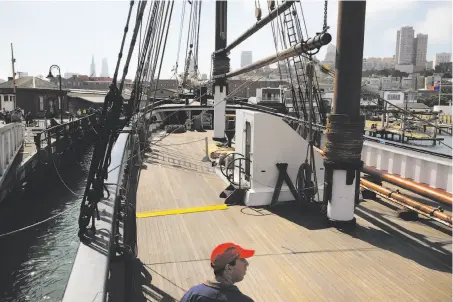  ?? Leah Millis / The Chronicle ?? Phil Perilstein from Philadelph­ia checks out the deck of lumber schooner C.A. Thayer in the San Francisco Maritime National Historical Park during a free day on Hyde Street Pier. Muir Woods also was free.
