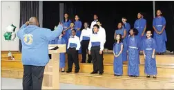  ?? COURTESY OF KAREN GOH ?? Kenneth Whitchard directs the McKinley Elementary Show Choir during a Community Awareness Day in December 2018.