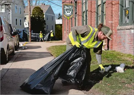  ?? DANA JENSEN/THE DAY ?? Thaler Hefel of Pawcatuck, right, and volunteers from Stonington High School, in background, pick up trash along Bayview Avenue and The Velvet Mill in Stonington during the Trash Talk Rally 2 on Saturday. See story on page D4.