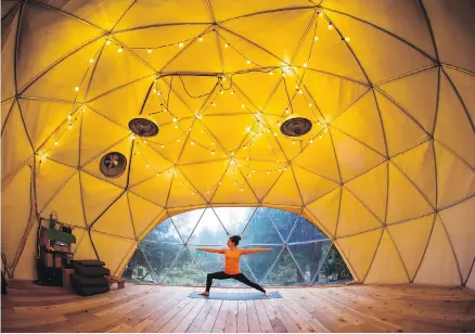  ??  ?? Nectar Yoga B&B owner Andrea Clark practises yoga in the geodesic dome at her property on Bowen Island.