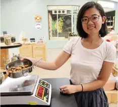  ??  ?? Zero Waste Malaysia founder Tin bringing her own container to buy cookies. — Filepic