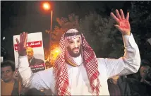  ?? LEFTERIS PITARAKIS — THE ASSOCIATED PRESS ?? An activist wearing a mask depicting Saudi Crown Prince Mohammed bin Salman holds up his hands painted with fake blood during a vigil for Saudi journalist Jamal Khashoggi in Istanbul on Thursday.