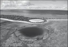  ?? CAROLYN COLE/TRIBUNE NEWS SERVICE ?? The U.S. Department of Energy has disclosed high levels of radiation in giant clams in a lagoon near the Runit Dome, where the U.S. entombed radioactiv­e waste from U.S. nuclear testing in the Marshall Islands almost four decade ago.