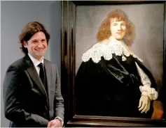  ??  ?? Six stands next to a Rembrandt painting called ‘Portrait of a Young Man’ at Hermitage Amsterdam. — Reuters photo