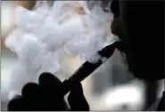  ?? NAM Y. HUH — THE ASSOCIATED PRESS FILE ?? A man smokes an electronic cigarette in Chicago.