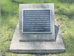  ??  ?? The memorial plaque in front of the granite cross.