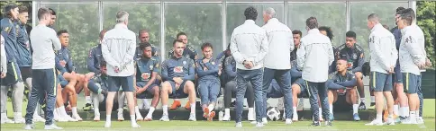  ??  ?? Brazil’s striker Neymar (centre) sits with teammates as they lisen to Brazil’s head coach Tite during a team training session at Tottenham Hotspur’s Enfield Training Centre, north-east of London ahead their Internatio­nal friendly football match against...