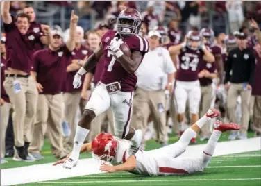  ?? Associated Press ?? Special teams: Texas A&amp;M kick returner Jashaun Corbin (7) avoids the diving tackle of Arkansas kicker Connor Limpert as he returns the opening kickoff for a touchdown.