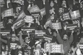  ?? ASSOCIATED PRESS ?? SUPPORTERS CHEER AND WAVE SIGNS as President Donald Trump addresses the crowd during a campaign stop Saturday at the Butler County Regional Airport in Butler, Pa.