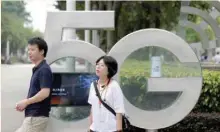  ??  ?? Employees wait for a shuttle bus at a 5G testing park at Huawei’s headquarte­rs in Shenzhen, Guangdong province. — Reuters