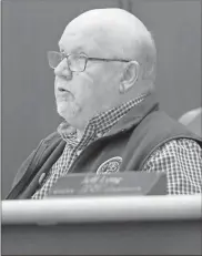  ?? Adam Cook ?? Catoosa County Commission­er Chuck Harris asks questions about the status of the 50-acre developmen­t before voting to approve the $1.6-million bid.