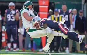  ?? Frank Franklin II / Associated Press ?? The New England Patriots’ J.C. Jackson, right, tackles the New York Jets’ Tyler Kroft during the second half on Sunday in East Rutherford, N.J.