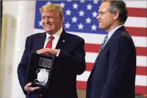  ?? Evan Vucci / Associated Press ?? Honeywell CEO Darius Adamczyk presents President Donald Trump with a framed N95 mask after a tour of a Honeywell Internatio­nal plant that manufactur­es personal protective equipment in Phoenix on May 5. The president currently has not received the first of two vaccinatio­n shots while President-elect Joe Biden was to receive his first vaccine shot on Monday.