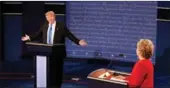  ?? RICK WILKING / REUTERS ?? Republican presidenti­al nominee Donald Trump speaks as Democratic presidenti­al nominee Hillary Clinton listens during their first presidenti­al debate at Hofstra University in New York on Monday.