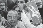  ??  ?? Brazil’s former President Luiz Inacio Lula da Silva is hugged by supporters after his swearing-in ceremony Thursday as the chief of staff to President Dilma Rousseff at the Planalto presidenti­al palace in Brasilia. Rousseff insisted Silva would help...