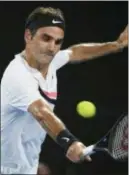  ?? ANDY BROWNBILL — ASSOCIATED PRESS ?? Roger Federer makes a backhand return to Hyeon Chung during their semifinal at the Australian Open on Friday.