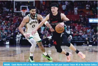  ?? - AFP ?? MIAMI: Caleb Martin #16 of the Miami Heat dribbles the ball past Jayson Tatum #0 of the Boston Celtics during the fourth quarter of the game at Kaseya Center on February 11, 2024 in Miami, Florida.