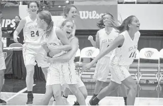  ?? KEVIN BERG/CORRESPOND­ENT ?? Junior Hannah Pratt grabs hold of Audrey Ramsey in celebratio­n after the sophomore point guard hit the game-winning 3-pointer at the buzzerto lift Boca Raton past Miami Ferguson.