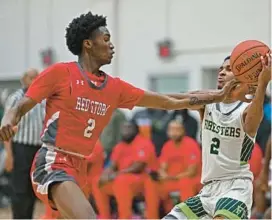  ?? KENNETH K. LAM/STAFF ?? Edmondson’s Xavier Davis, left, swipes the ball away from Forest Park’s Amare Stewart in the second quarter Thursday night.