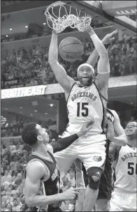  ?? AP/BRANDON DILL ?? Memphis Grizzlies guard Vince Carter (15) dunks in two of his 12 points between San Antonio Spurs forward LaMarcus Aldridge and guard Danny Green in the Spurs 103-96 victory. San Antonio won the series 4-2 and will meet Houston in the second round.