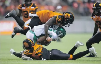  ?? THE CANADIAN PRESS/FILES ?? Lions linebacker Micah Awe, top, says avoiding high hits is “something I need to work on” after he was fined $2,100 for a pair of tackles he made on Calgary players last weekend.