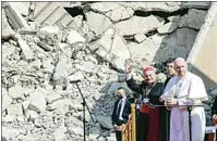  ??  ?? Mosul and Aqra Archbishop Najib Mikhael Moussa, left, waves as he stands next to Pope Francis on Sunday at the start of a gathering to pray for the victims of war at Hosh al-Bieaa Church Square, in Mosul, Iraq, once the de-facto capital of IS.