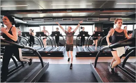  ?? Chelsea Lauren ?? DAVID SIIK developed and here leads a Precision Run treadmill class at Equinox. Move those arms front to back, not side to side.