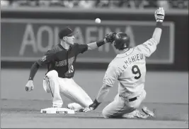  ?? ASSOCIATED PRESS ?? COLORADO ROCKIES’ DJ LEMAHIEU (9) advances to second base under a tag by Arizona Diamondbac­ks shortstop Nick Ahmed (left) after a line-out by Nolan Arenado in the ninth inning of Saturday’s game in Phoenix.