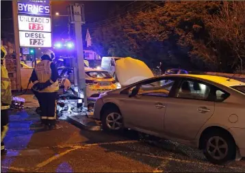  ??  ?? Firefighte­rs and Gardaí at the scene of the accident in which a petrol pump was demolished.