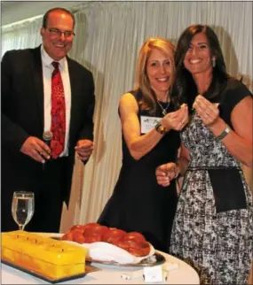  ??  ?? Event co-chairs Julie Nagorsky and Jen Toren participat­e in the blessing of the bread (challah).