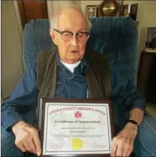  ?? PHOTO SPECIAL TO THE DISPATCH BY MIKE JAQUAYS ?? Fred Langford of Vernon holds a plaque from the Oneida County Sheriff’s office at his Vernon home on Friday, March 17, 2017. He received that commemorat­ion of his service to the Vernon Volunteer Fire Department earlier this month.