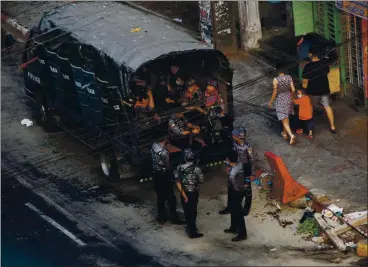  ?? PHOTOS BY THE ASSOCIATED PRESS ?? Security forces stand by in the Kamayut township of Yangon in Myanmar on Monday. The military overthrew the elected government, jailed Aung San Suu Kyi and other civilian leaders and killed and imprisoned protesters in the country.