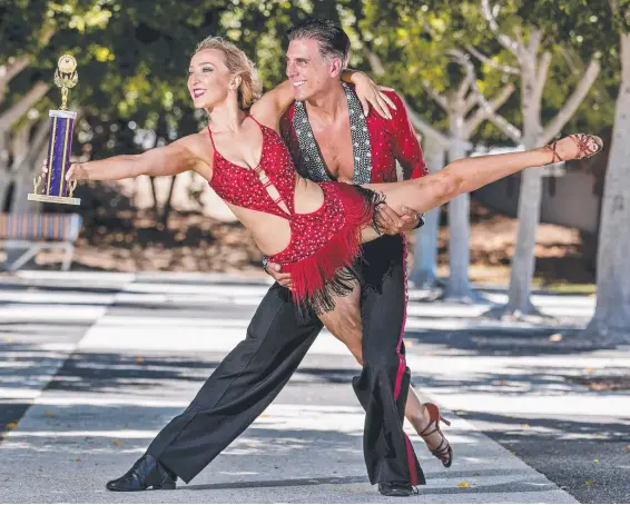  ?? Picture: JERAD WILLIAMS ?? Andre Vermast, 48, from Nerang, with dance partner Kristi Hall, has returned from the World Latin Dance Cup with an individual title.